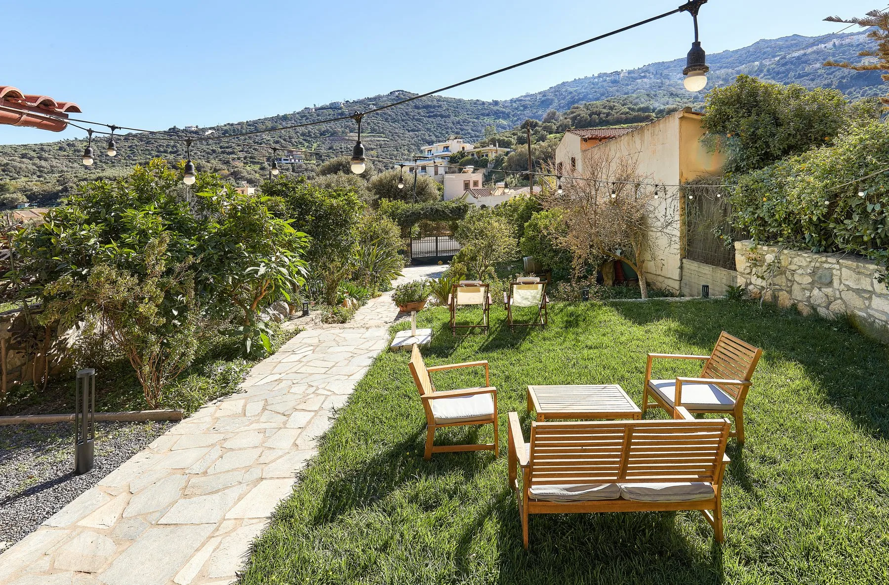 Private garden with outdoor seating and citrus trees at a house in Paleokastro Private garden with outdoor seating and citrus trees at a house in Paleokastro
