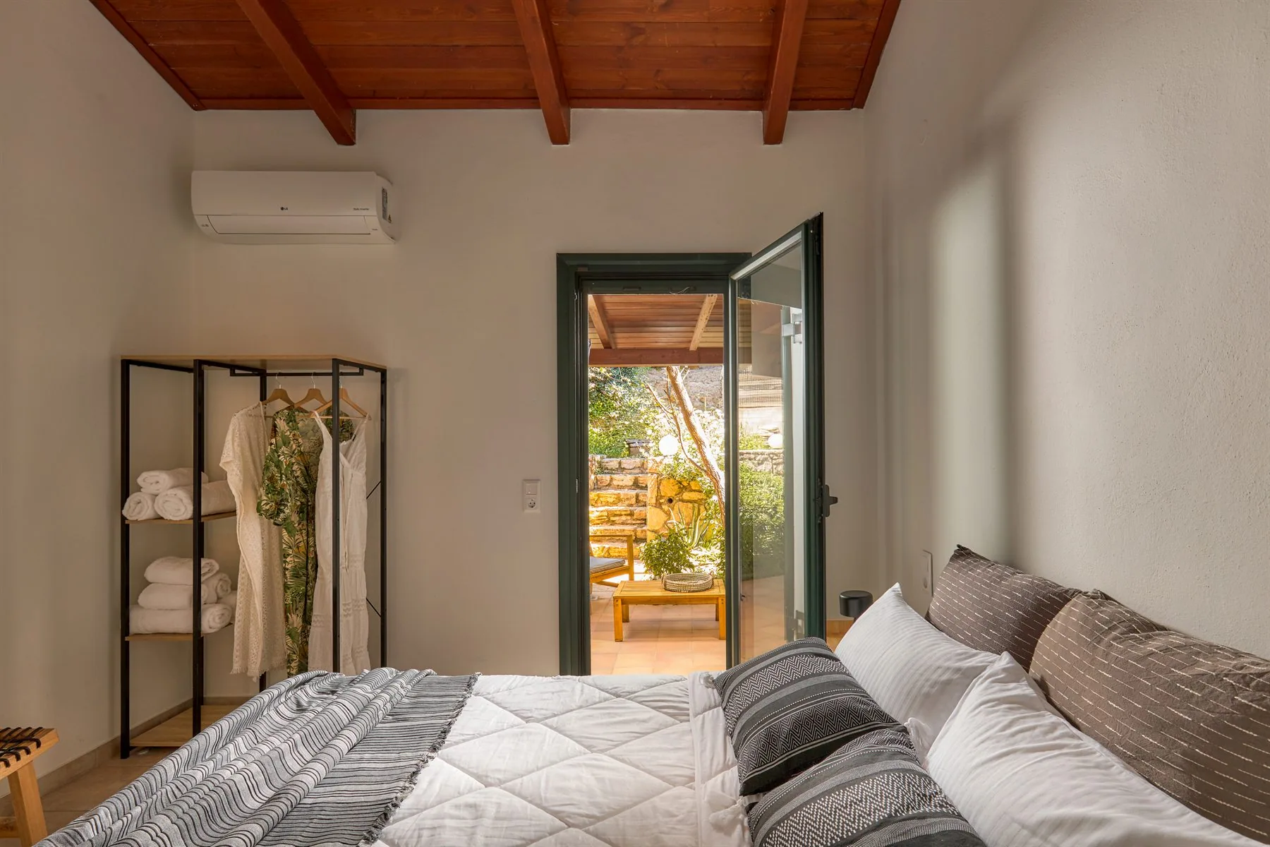 Bedroom with balcony access and natural light at Yiamas Seaside Cottage Bedroom with balcony access and natural light at Yiamas Seaside Cottage