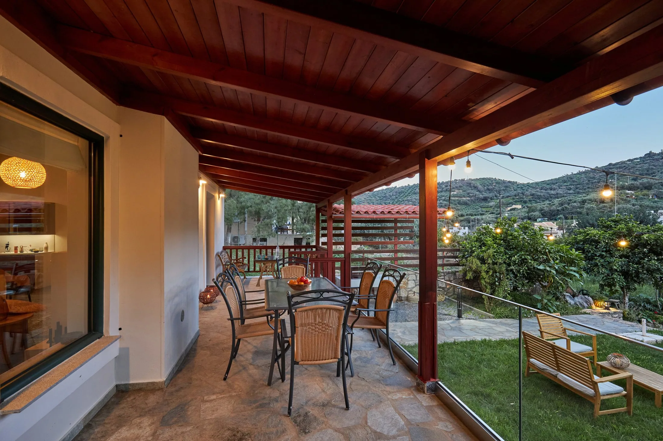 Covered veranda with outdoor dining at Yiamas Seaside Cottage in Paleokastro