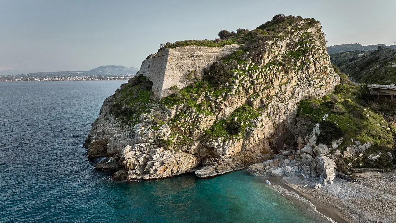 Paleokastro bay with clear water below the old castle near Heraklion Crete
